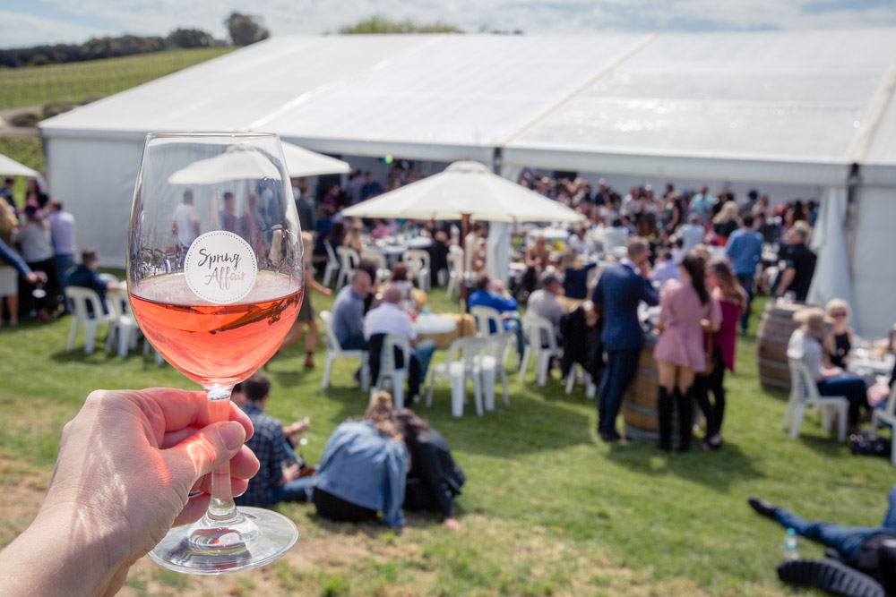 glass of rose raised